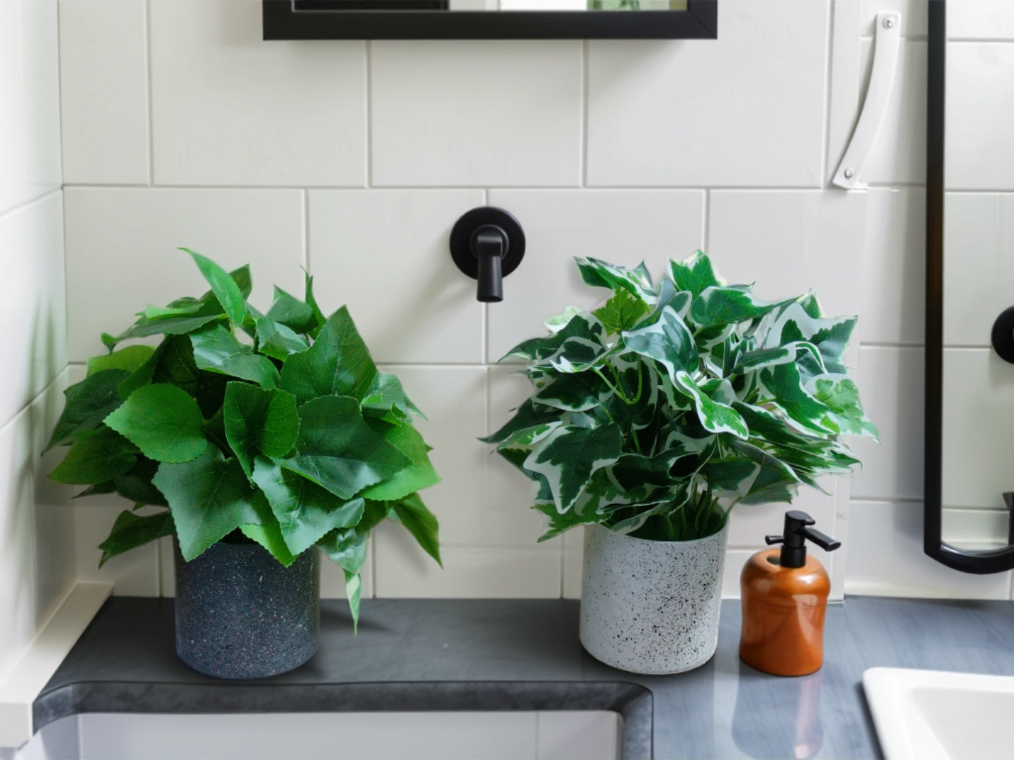 Set of two small artificial green plants in dark and light grey speckled pots, featuring Hedera and variegated ivy foliage.