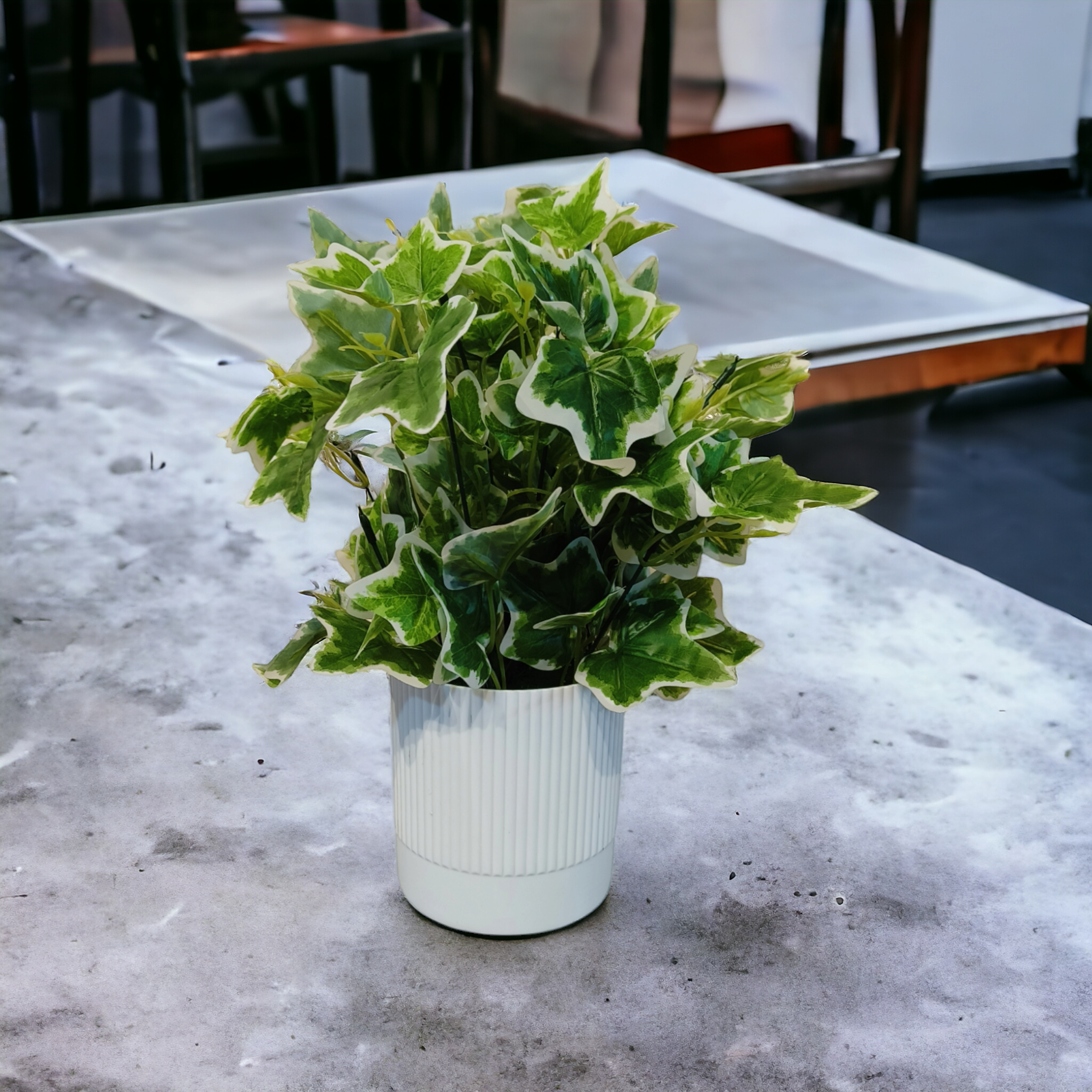 Artificial Hedera Ivy plant with variegated green and white leaves in a white ribbed PVC pot.