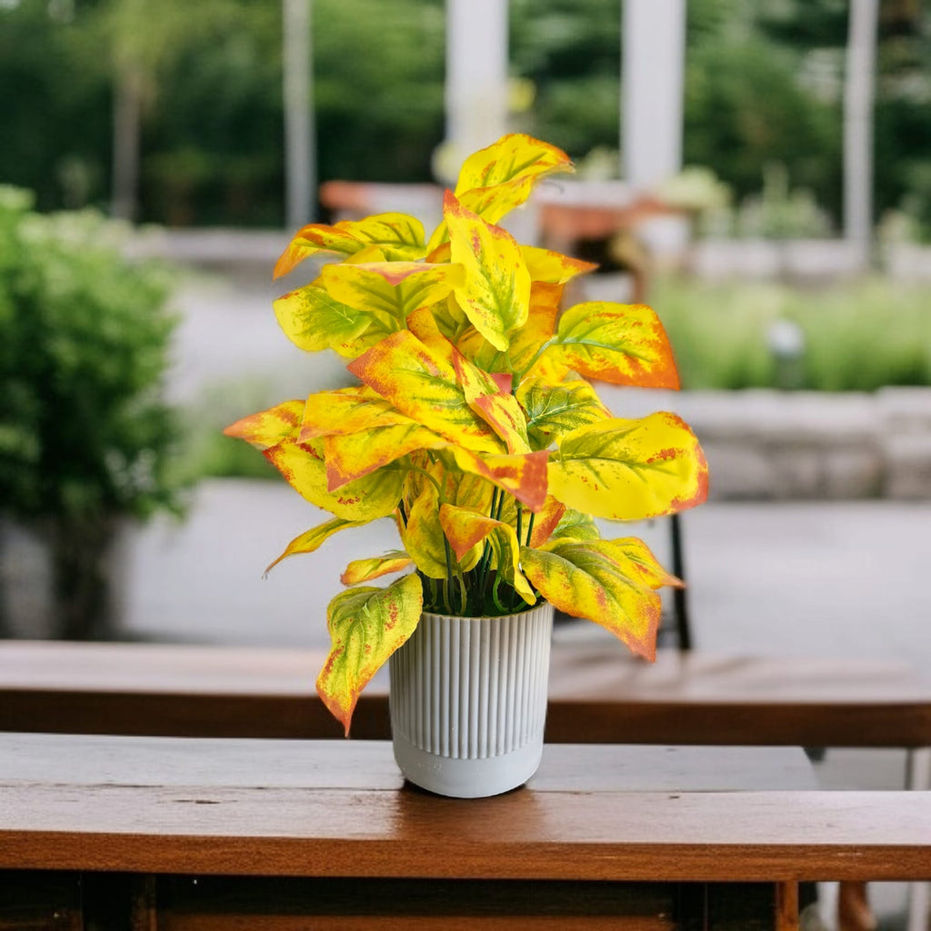Artificial Golden Pathos plant with vibrant yellow and green variegated leaves in a grey ribbed PVC pot.